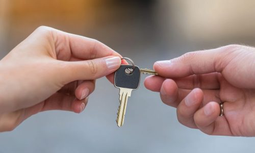 vecteezy_a-couple-holding-a-key-to-a-house_69274468